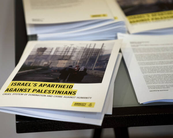 Photo of printed copies of Amnesty International's report on a table.