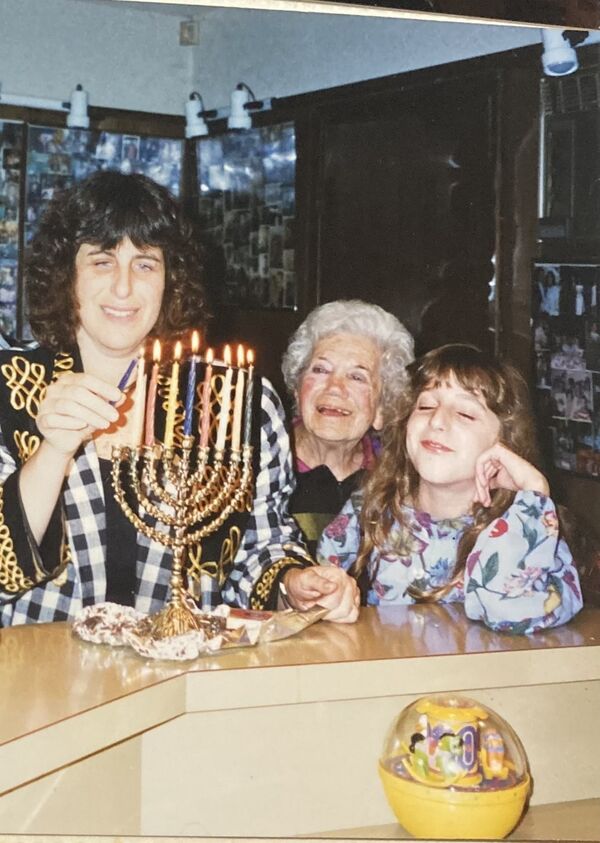 Young Ari celebrating with their mother and great-grandmother.